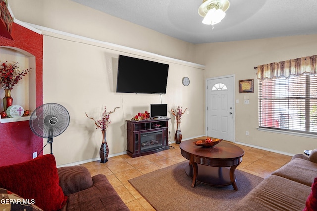 living room with light tile patterned flooring, vaulted ceiling, and ceiling fan