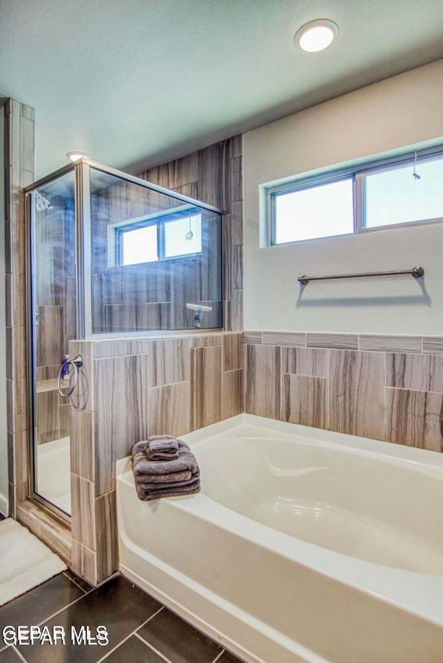 bathroom featuring separate shower and tub, a wealth of natural light, and tile patterned floors