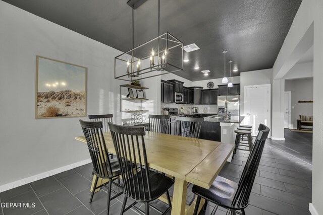 dining space with an inviting chandelier and a textured ceiling