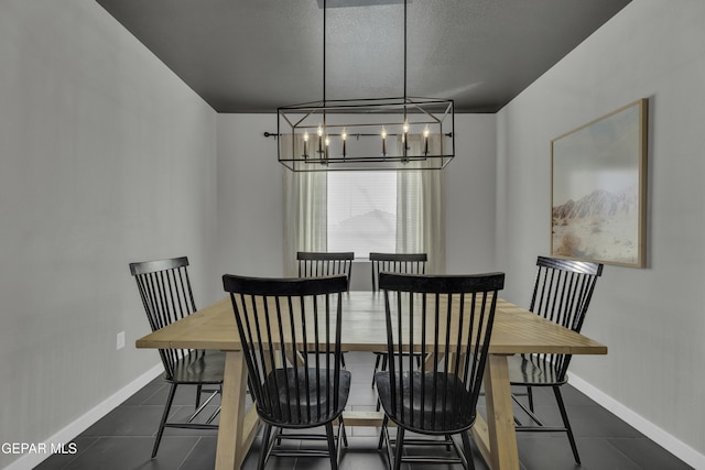 tiled dining area featuring a textured ceiling