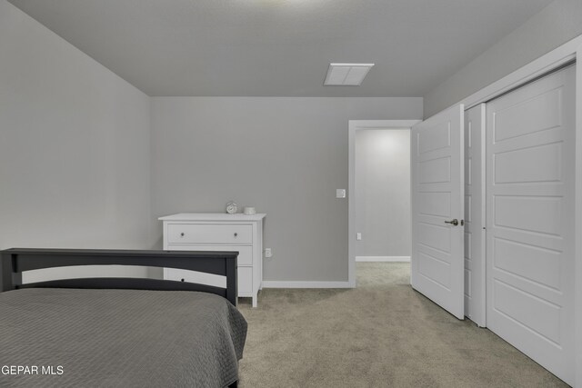 unfurnished bedroom featuring light carpet and a closet