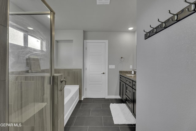 bathroom featuring vanity, tile patterned floors, and plus walk in shower