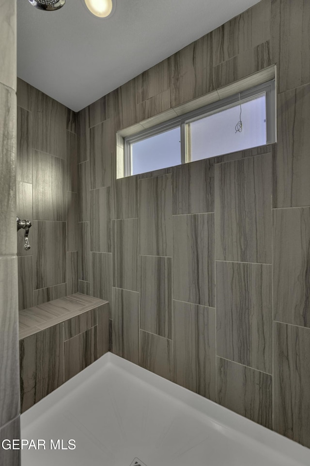 bathroom featuring tiled shower