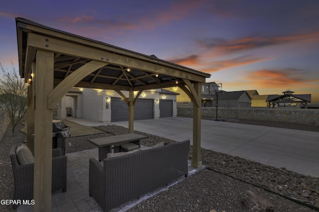 patio terrace at dusk featuring a gazebo