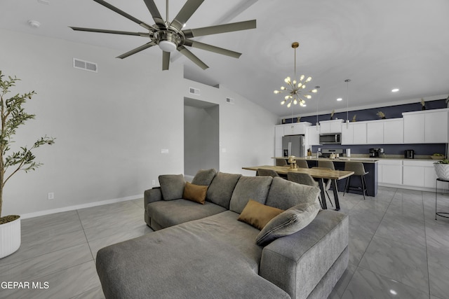 living room with ceiling fan with notable chandelier and high vaulted ceiling