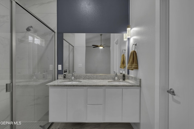 bathroom with an enclosed shower, vanity, and ceiling fan