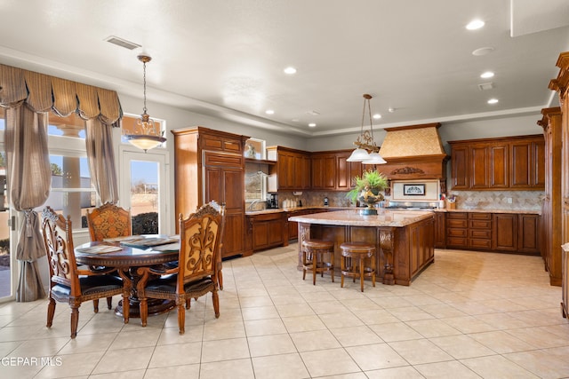 kitchen featuring backsplash, decorative light fixtures, and a center island