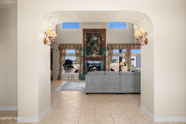 living room featuring light tile patterned flooring and a fireplace