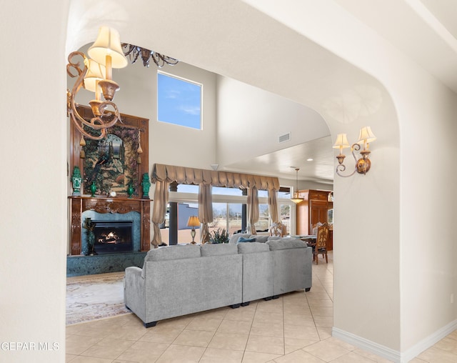 living room with a premium fireplace and light tile patterned flooring