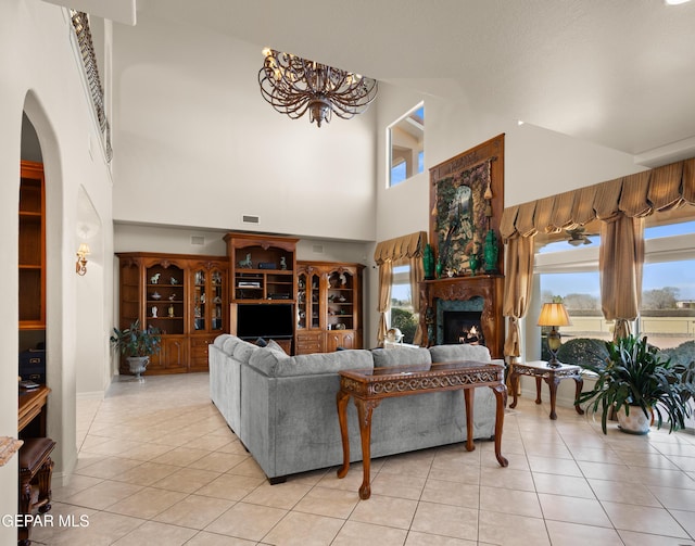 living room featuring a towering ceiling, plenty of natural light, and light tile patterned flooring