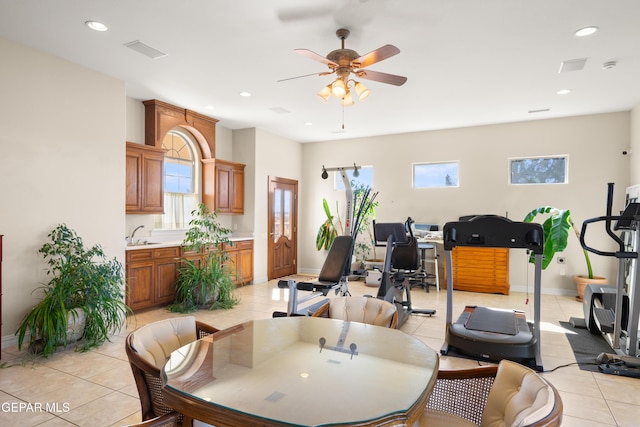 dining area with a wealth of natural light, sink, and light tile patterned floors