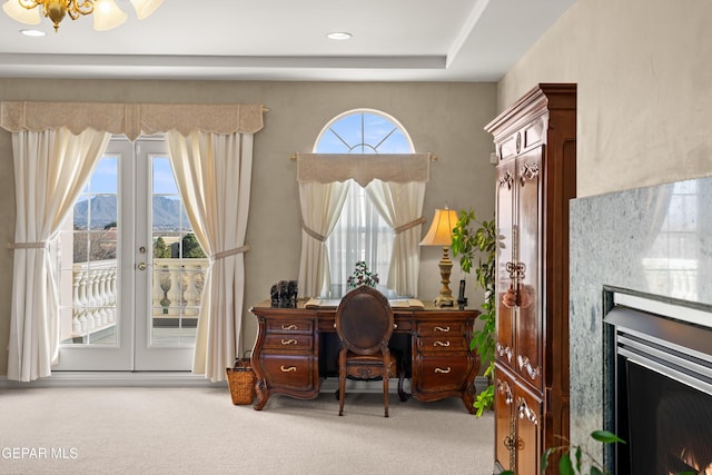 carpeted office with french doors and a mountain view