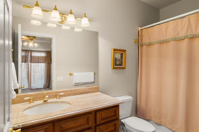 bathroom featuring vanity, toilet, and curtained shower