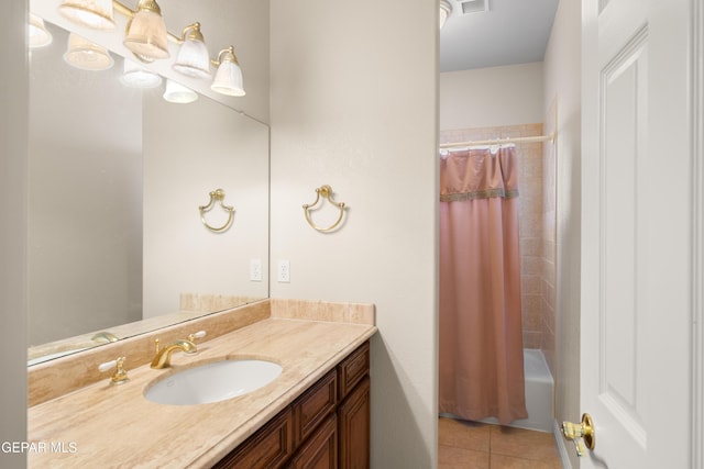 bathroom featuring shower / bath combo with shower curtain, tile patterned floors, and vanity