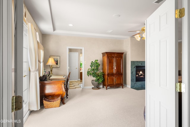 sitting room with ceiling fan and carpet flooring