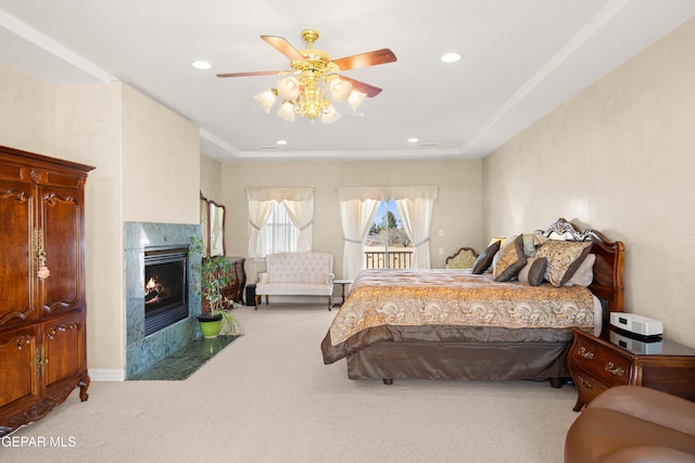 carpeted bedroom featuring ceiling fan and a high end fireplace