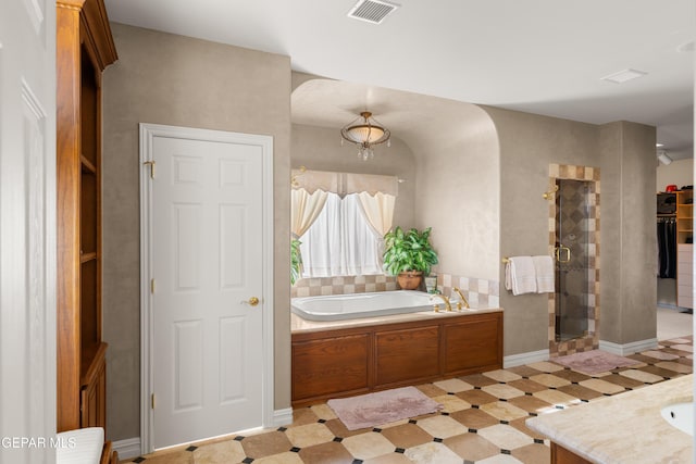 bathroom featuring vanity and plus walk in shower