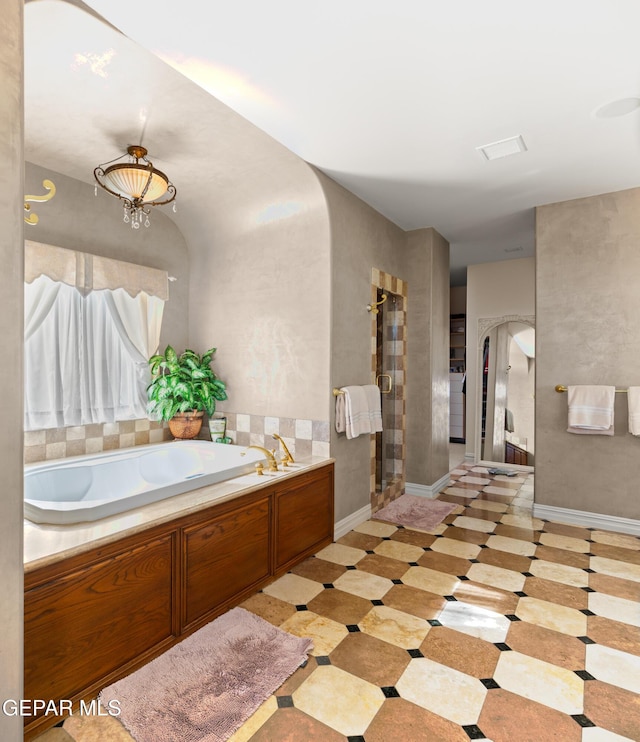 bathroom with a tub to relax in