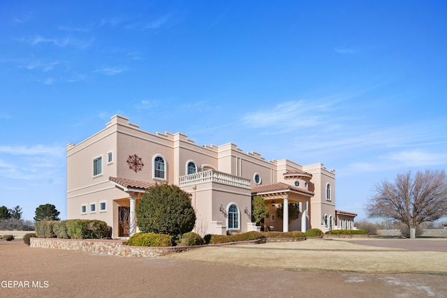 mediterranean / spanish-style house featuring a balcony