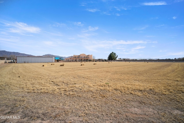 view of yard with a rural view