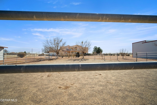 view of yard with a rural view and an outbuilding