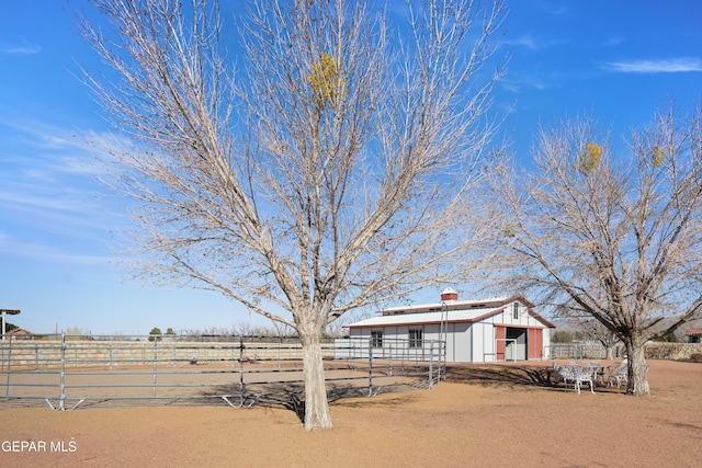 view of yard featuring an outbuilding and a rural view