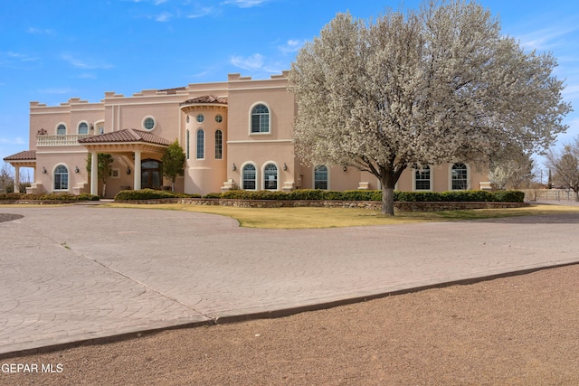 view of front of home featuring a tile roof and stucco siding