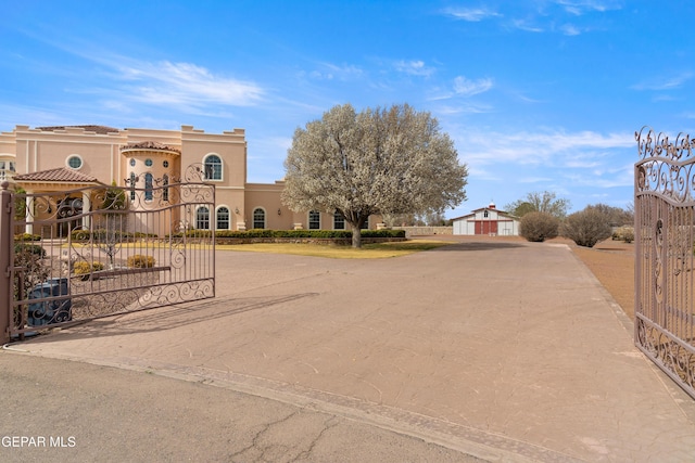 view of front facade with an outbuilding and stucco siding