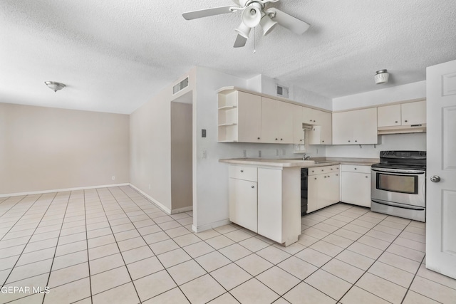 kitchen with electric stove, sink, ceiling fan, a textured ceiling, and light tile patterned flooring