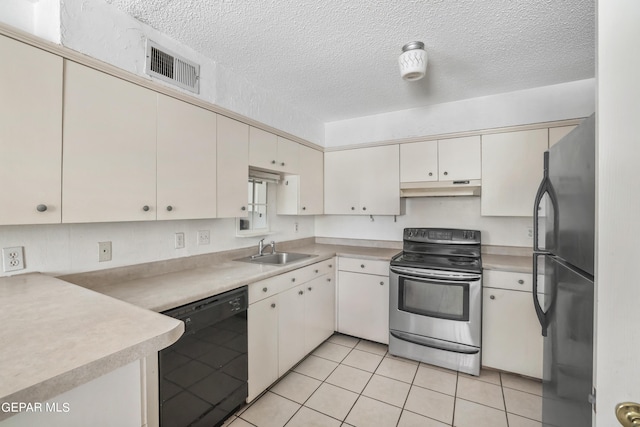 kitchen featuring white cabinetry, sink, light tile patterned floors, black appliances, and a textured ceiling