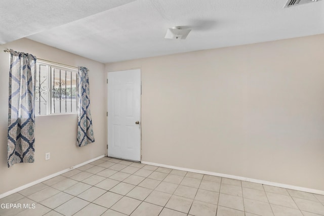 spare room featuring a textured ceiling