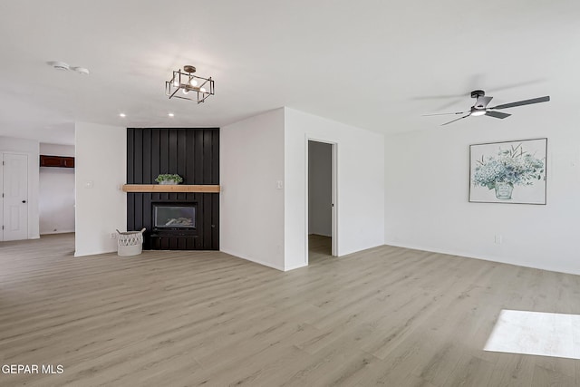 unfurnished living room with light hardwood / wood-style flooring, a fireplace, and ceiling fan