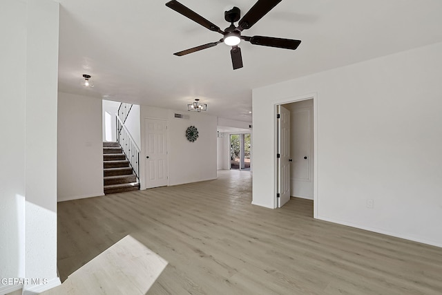 unfurnished living room featuring ceiling fan and light hardwood / wood-style flooring