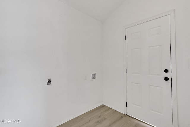 interior space with hookup for a washing machine, electric dryer hookup, and light hardwood / wood-style flooring