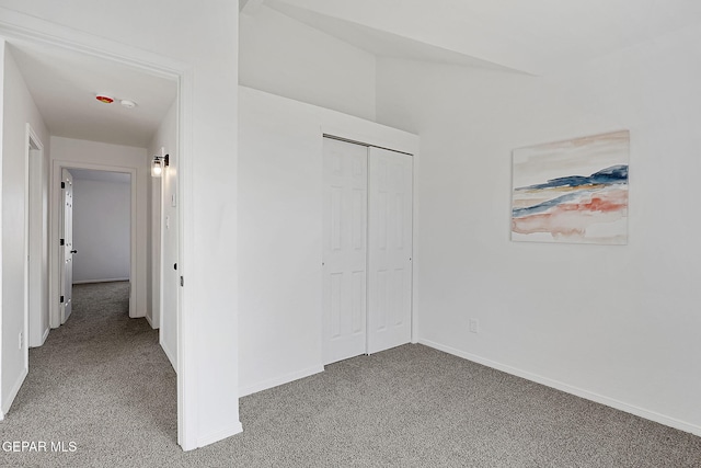 unfurnished bedroom featuring carpet flooring and a closet