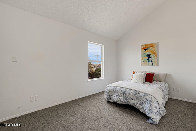 carpeted bedroom with lofted ceiling and a textured ceiling