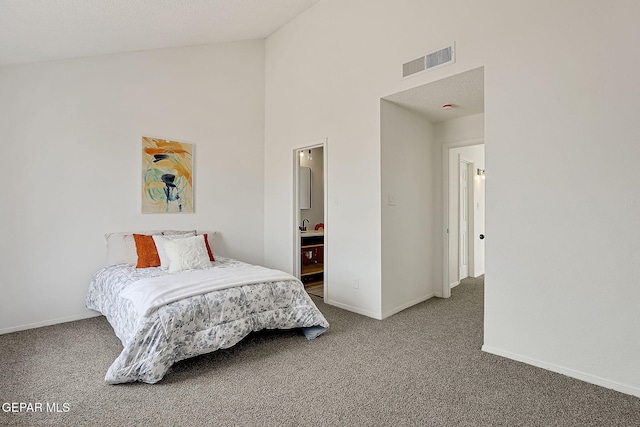 carpeted bedroom featuring connected bathroom and high vaulted ceiling