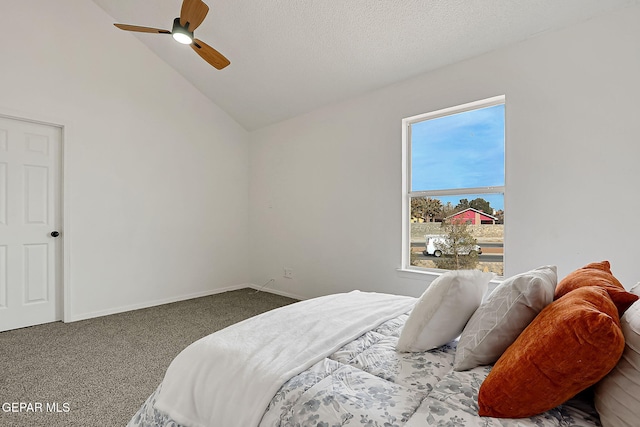 carpeted bedroom with ceiling fan, lofted ceiling, and a textured ceiling