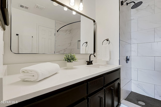 bathroom featuring vanity and a tile shower