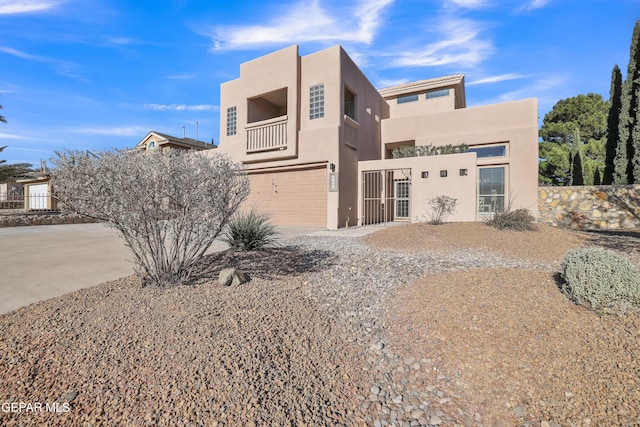 view of front of house featuring a garage and a balcony