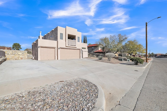 view of front of property featuring a balcony and a garage