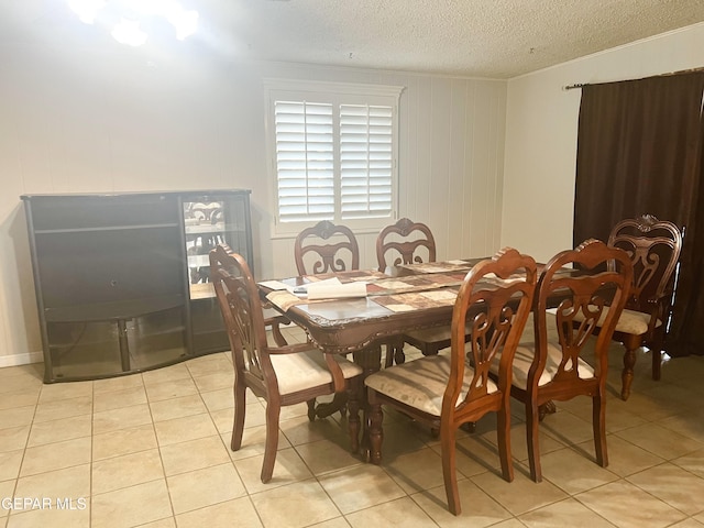 dining room with a textured ceiling and light tile patterned floors