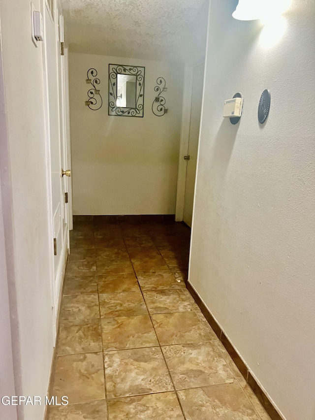 hallway with a textured ceiling