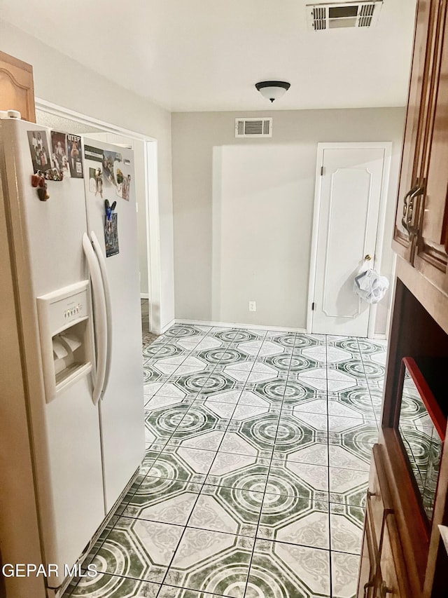 kitchen with white fridge with ice dispenser