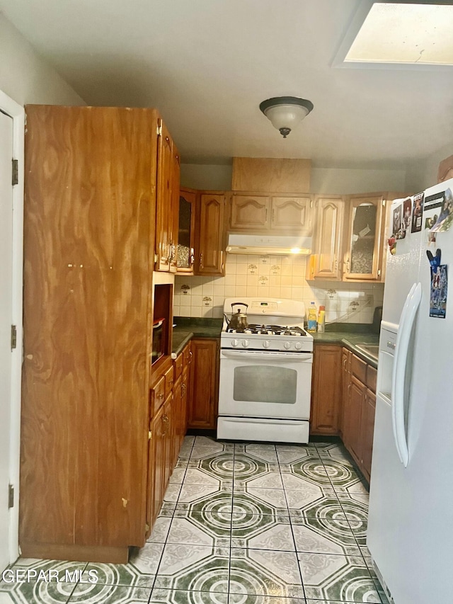 kitchen with white appliances and decorative backsplash