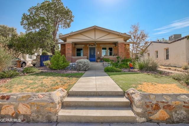 view of front of house featuring a front lawn and covered porch