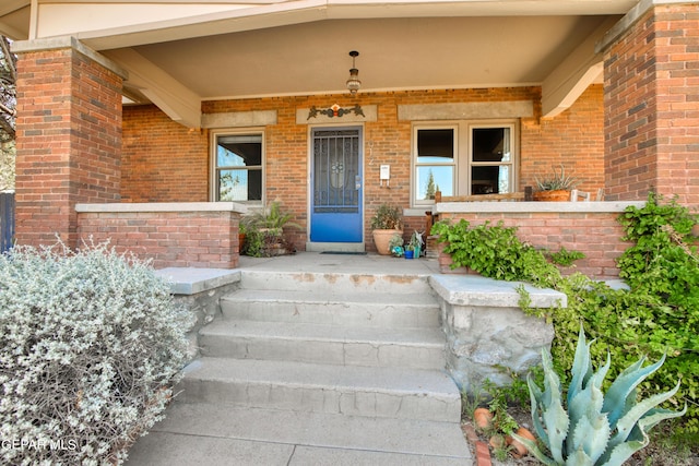 view of exterior entry with covered porch