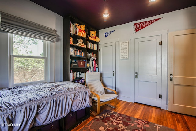 bedroom with hardwood / wood-style floors