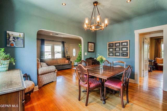 dining room featuring an inviting chandelier and light hardwood / wood-style floors