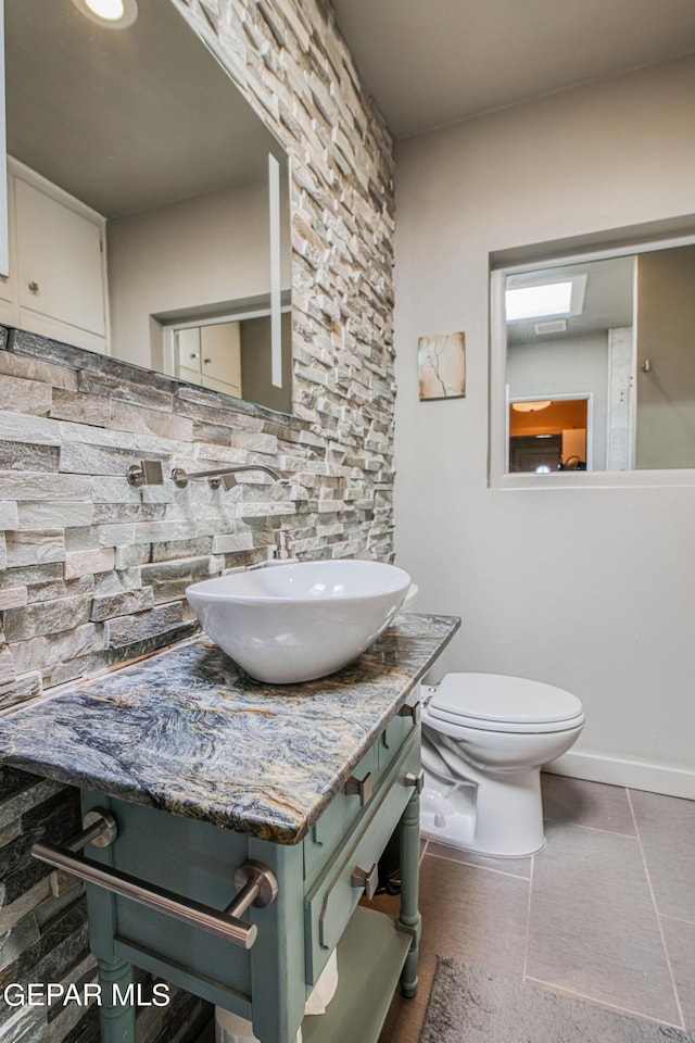 bathroom with vanity, tile patterned flooring, and toilet